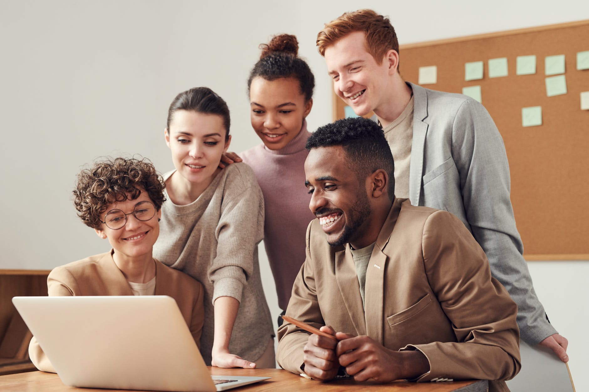 Happy startup founders working together on a laptop